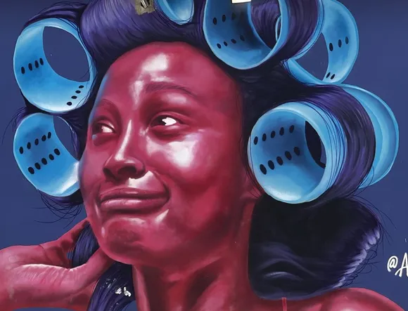 Street art in the Dominican Republic showing a woman with her hair in rollers