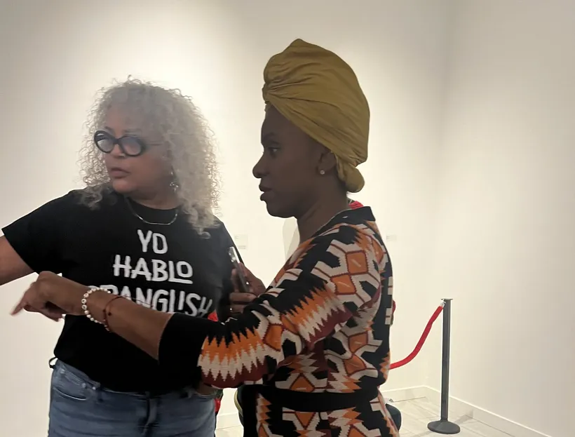 Tami in conversation at a gallery
